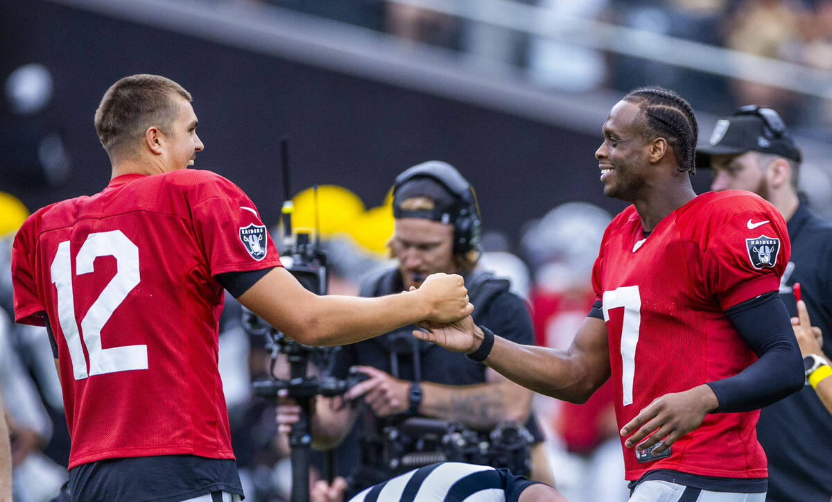 Raiders quarterbacks Aidan O'Connell (12) and Geno Smith (7) shake hands after a coin toss duri ...