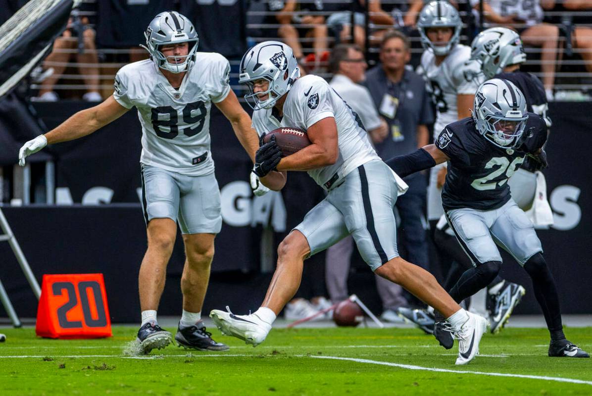 Raiders tight end Michael Mayer (87) looks for room to run after a catch during the first half ...