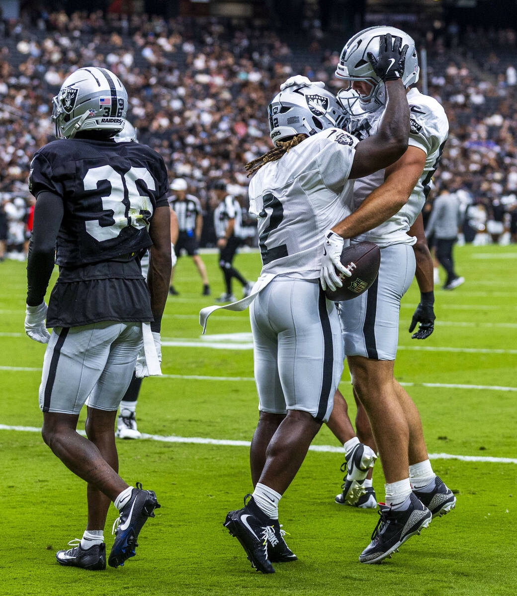 Raiders tight end Brock Bowers (89) is congratulated on a touchdown pass by running back Ashton ...