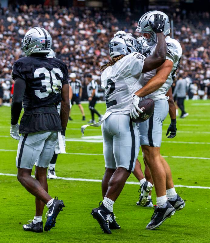Raiders tight end Brock Bowers (89) is congratulated on a touchdown pass by running back Ashton ...