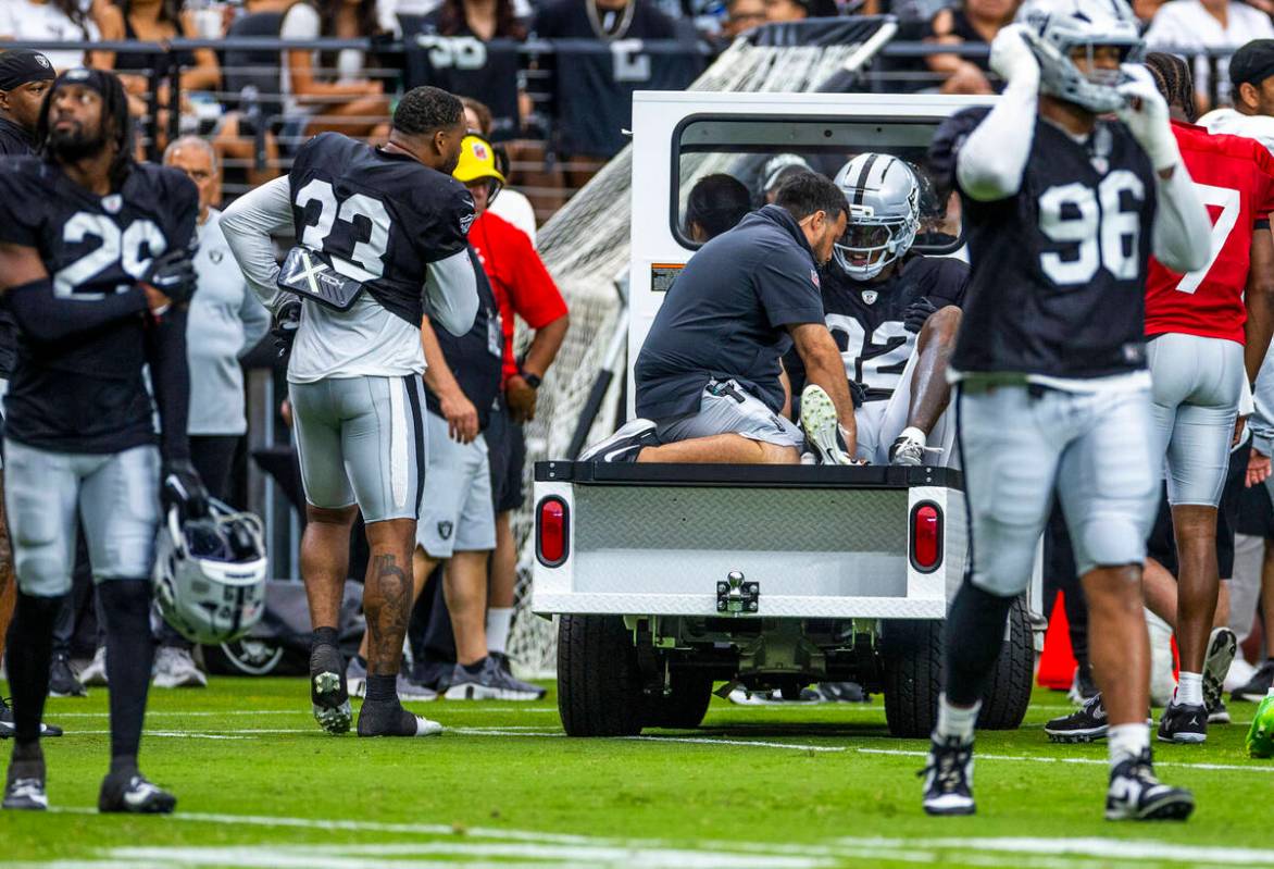 Raiders cornerback Lonnie Johnson Jr. (32) is carted off as he appears to have a leg injury dur ...