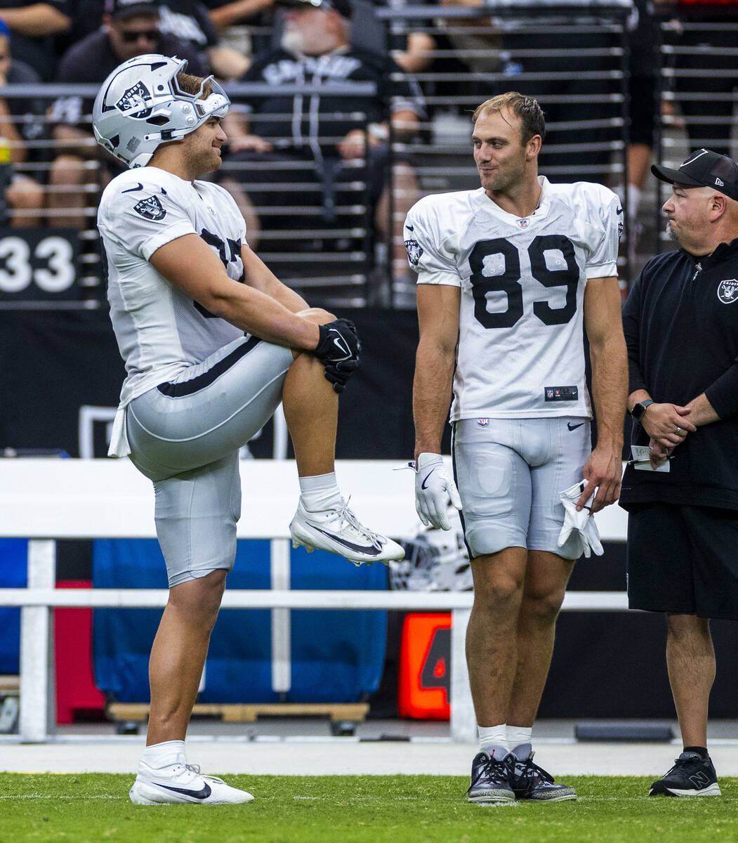 Raiders tight end Michael Mayer (87) and tight end Brock Bowers (89) chat on the sidelines duri ...