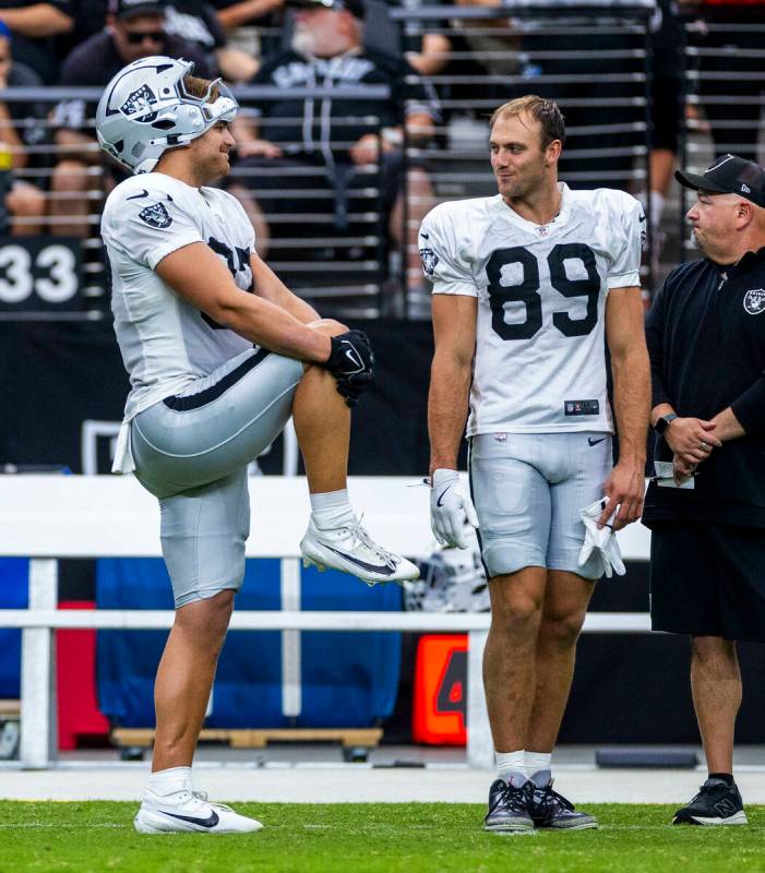 Raiders tight end Michael Mayer (87) and tight end Brock Bowers (89) chat on the sidelines duri ...