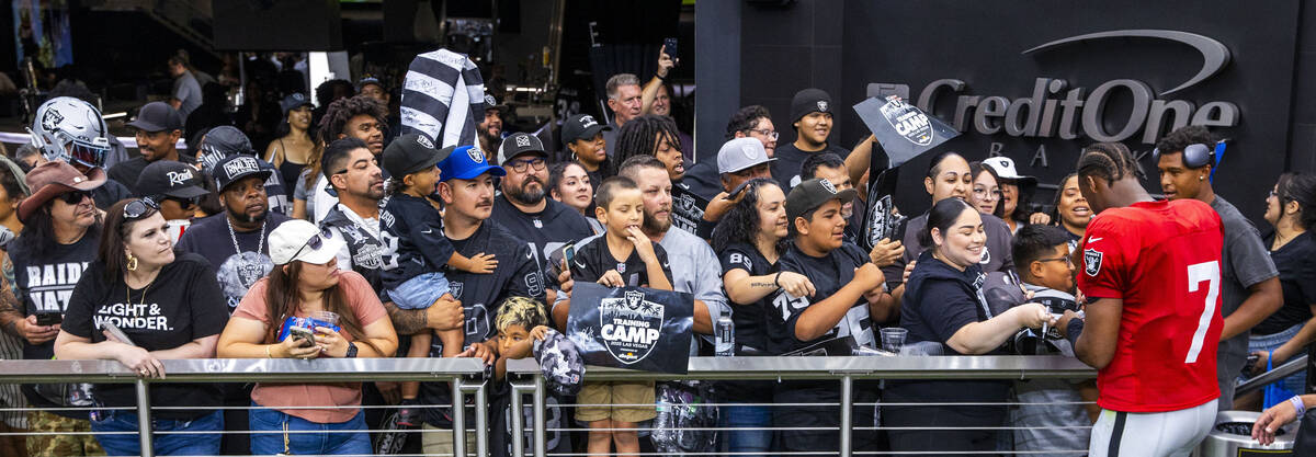 Raiders quarterback Geno Smith (7) signs autographs following the second half of a Raiders trai ...