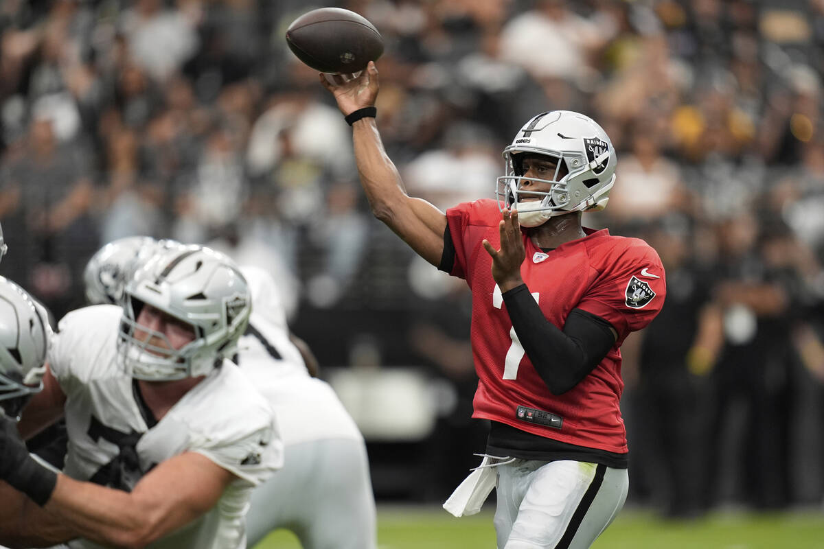 Las Vegas Raiders quarterback Geno Smith (7) throws at the team's NFL football training camp Sa ...