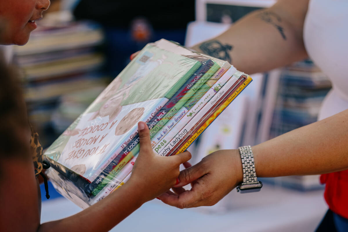The Clark County School District’s Early Childhood Department gives out stacks of books ...