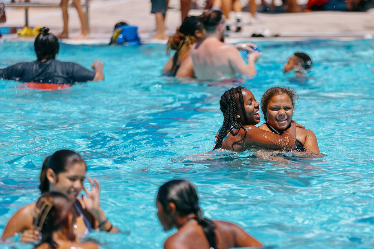 Friends Tenyzja Patterson, 11, and Zaya Nolbert, 12, play in the pool during the City of North ...