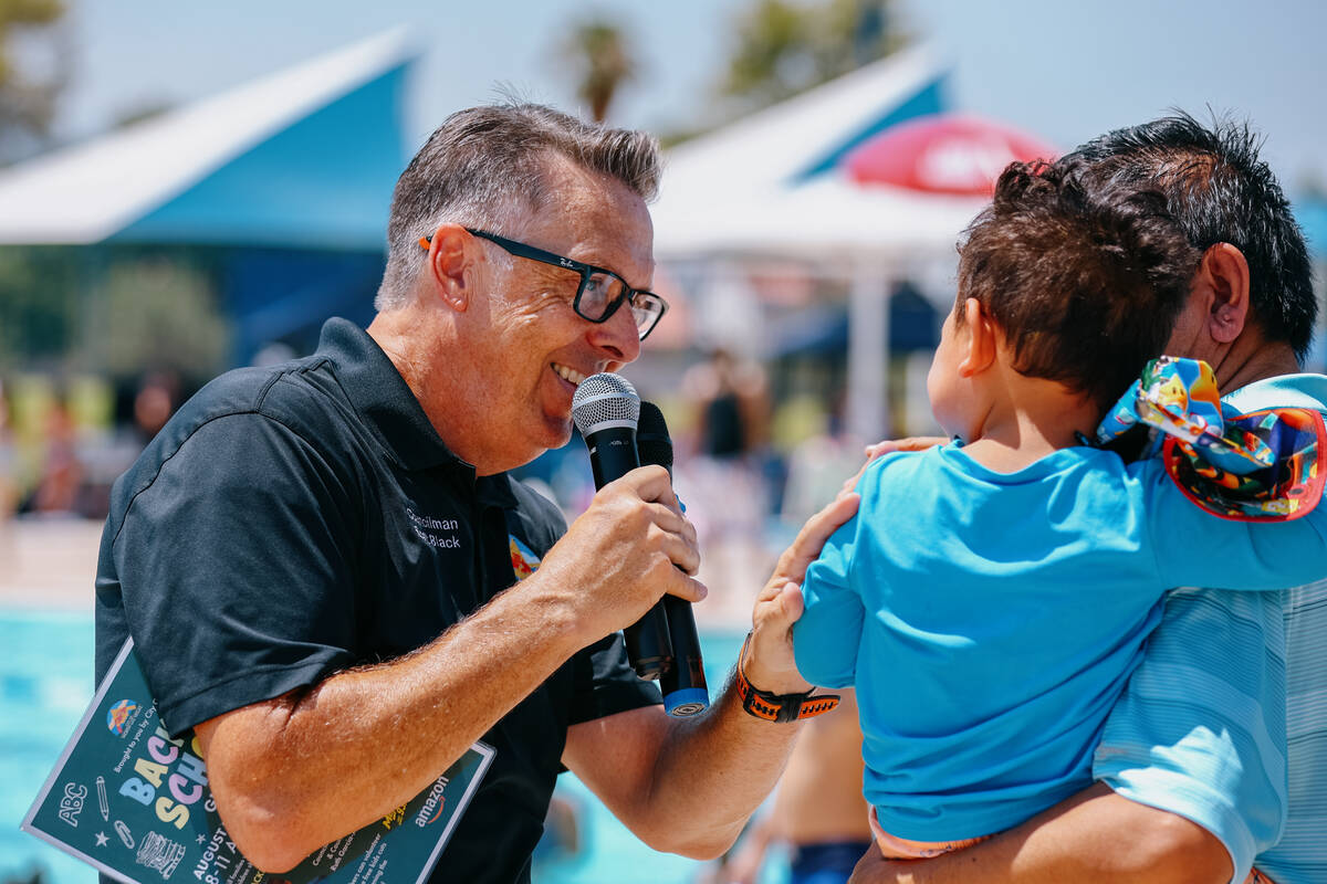 Ward Three Councilman Scott Black speaks with Ward One Councilman Isaac Barron’s son dur ...