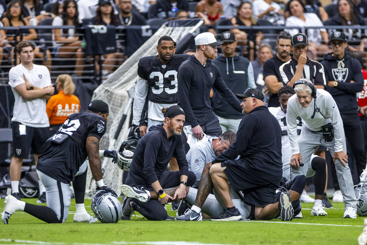 Raiders coach Pete Carroll, far right, joins his team in concern as cornerback Lonnie Johnson J ...