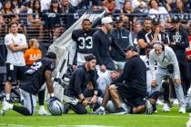 Raiders coach Pete Carroll, far right, joins his team in concern as cornerback Lonnie Johnson J ...