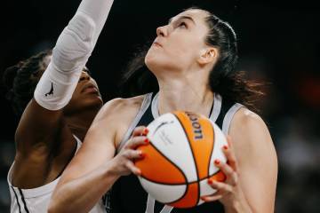 Aces center Megan Gustafson (17) puts up a shot during a WNBA game between the Aces and Golden ...