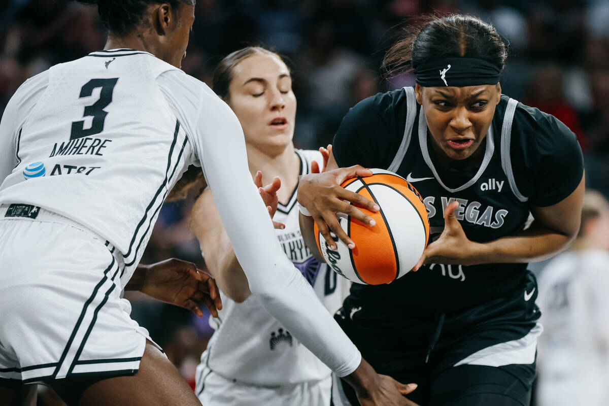 Aces forward NaLyssa Smith (3) keeps hold of the ball as Golden State Valkyries defense closes ...