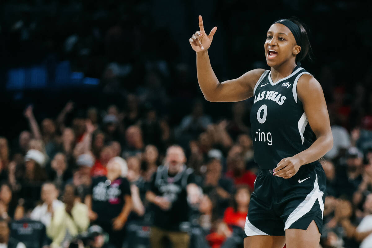 Aces guard Jackie Young (0) celebrates a shot by a teammate during a WNBA game between the Aces ...