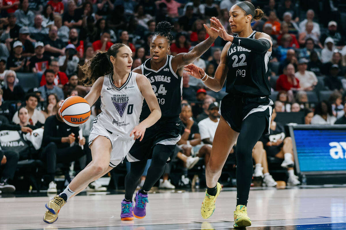 Golden State Valkyries guard Carla Leite (0) dribbles the ball as Aces guard Jewell Loyd (24) a ...