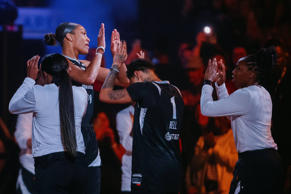 Aces center A'ja Wilson high-fives her teammates during a WNBA game between the Aces and Golden ...