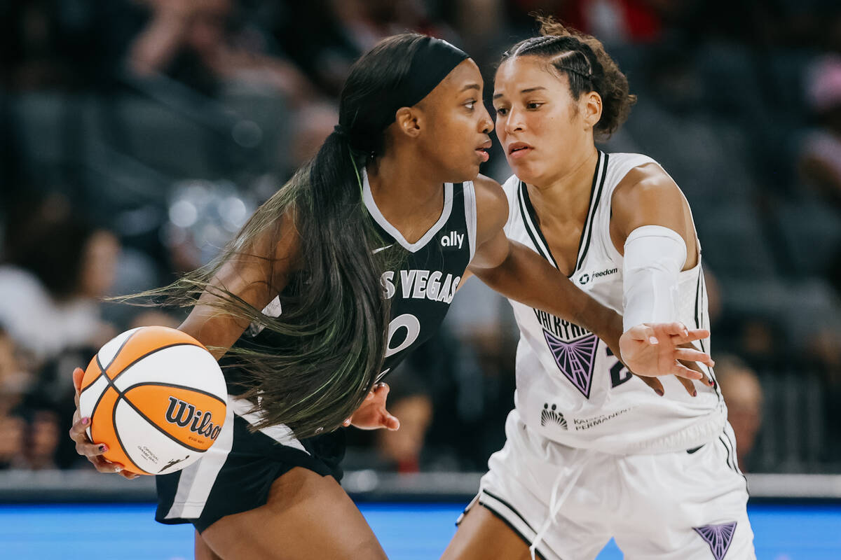 Aces guard Jackie Young (0) dribbles the ball against Golden State Valkyries guard Veronica Bur ...