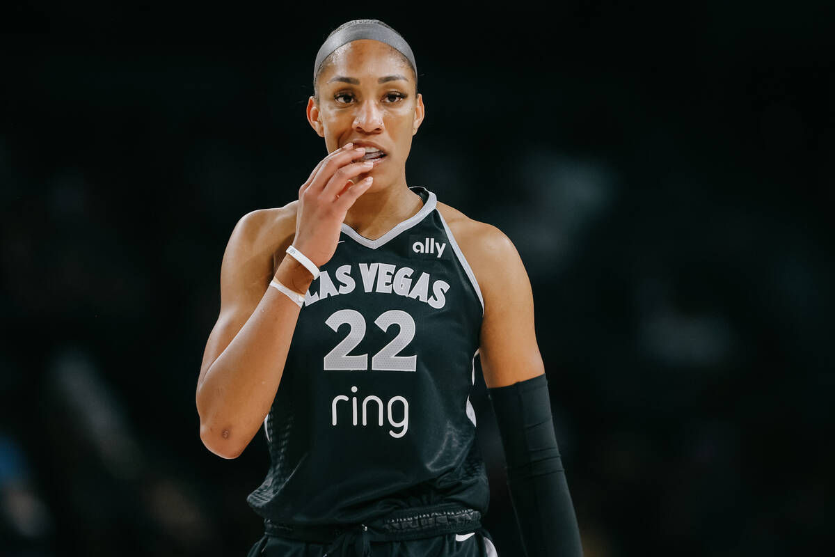 Aces center A'ja Wilson (22) puts her mouthguard back in during a WNBA game between the Aces an ...