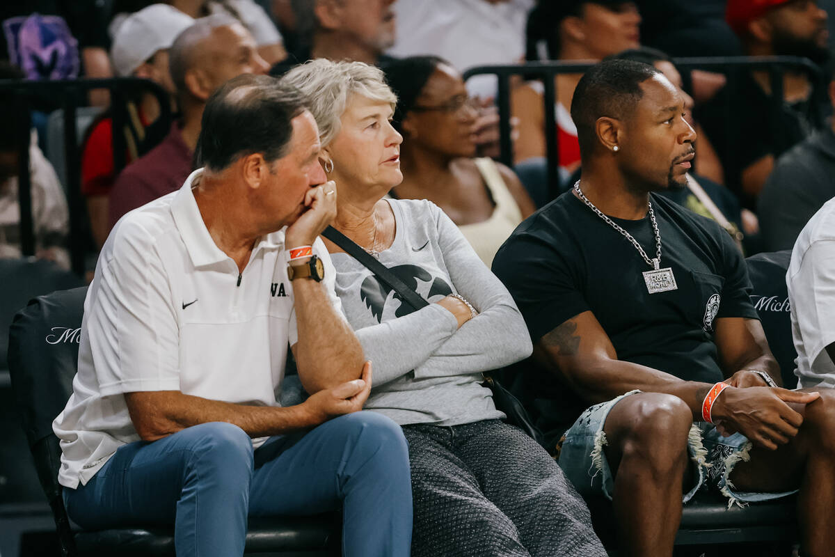 Former Iowa women’s basketball coach Lisa Bluder, middle, watches game action during a W ...