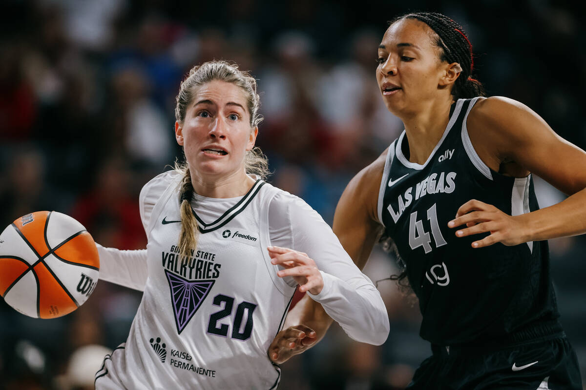 Golden State Valkyries guard Kate Martin (20) dribbles the ball against Aces center Kiah Stokes ...