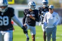 Raiders cornerback Decamerion Richardson (25) runs with head coach Pete Carroll on warm ups dur ...