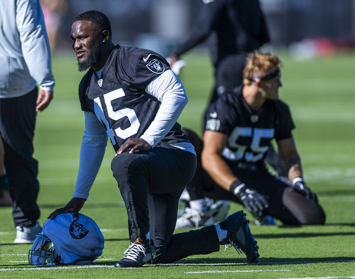 Raiders linebacker Devin White (45) stretches with teammates during the first day of training c ...