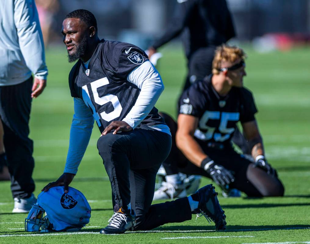 Raiders linebacker Devin White (45) stretches with teammates during the first day of training c ...