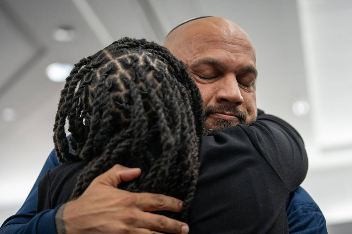Tamara Russell embraces her brother-in-law Kevin Menon before his sentencing hearing Monday in ...
