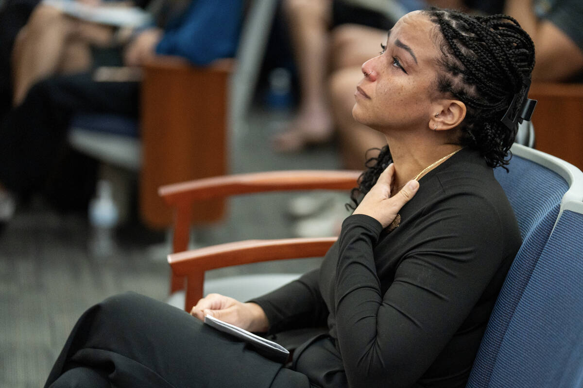 Natasha Menon cries as her husband, Kevin Menon, a former Metropolitan Police Department sergea ...