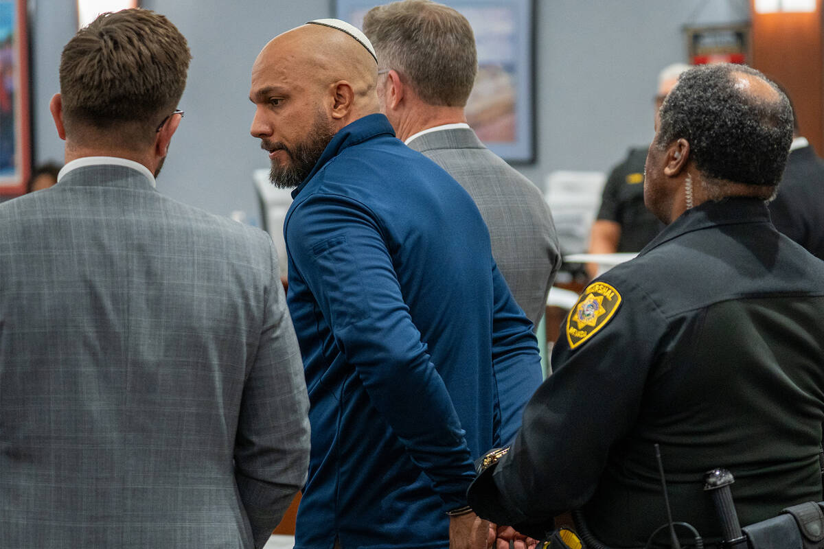 Kevin Menon, a former Metropolitan Police Department sergeant, is taken into custody during a s ...