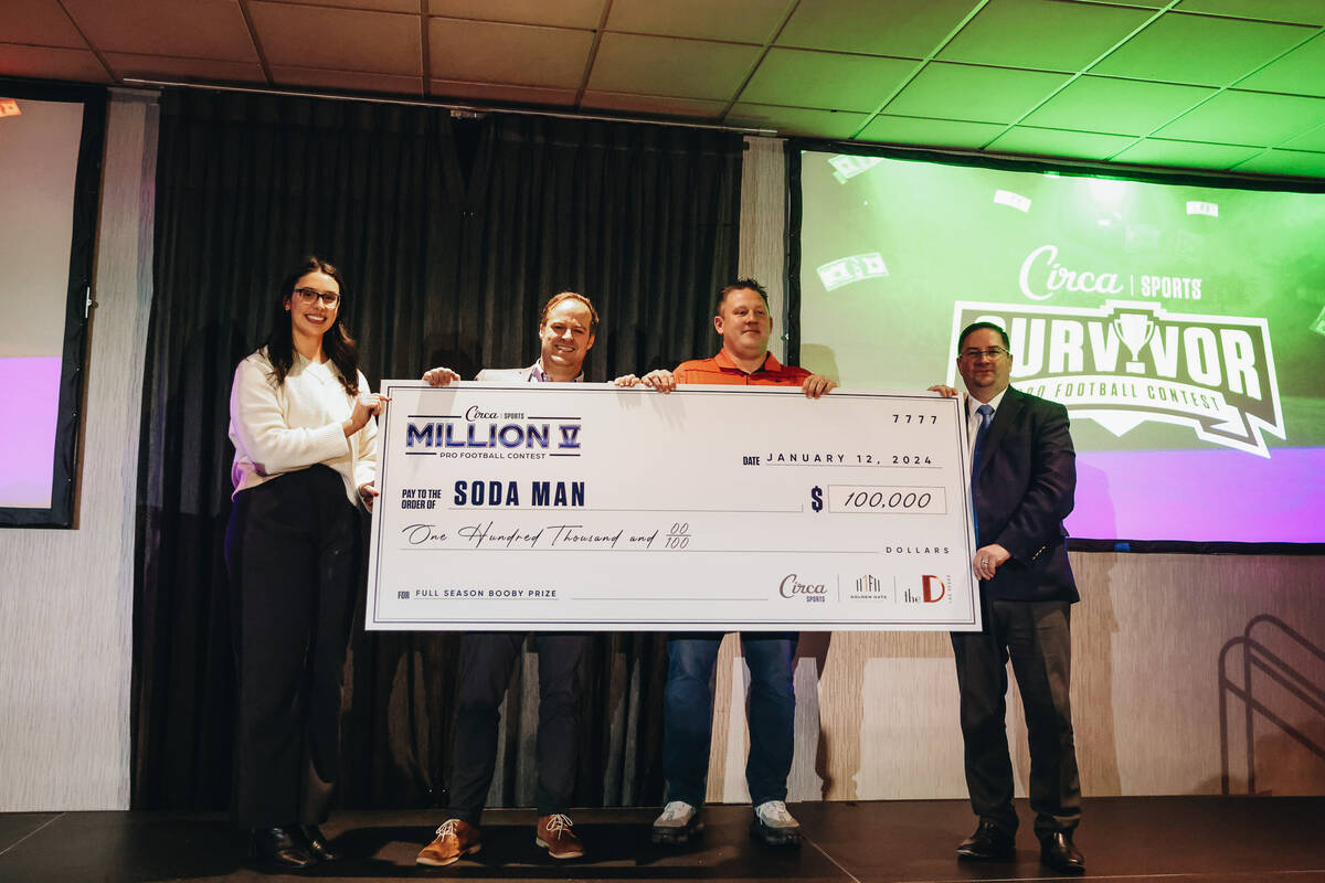 Circa Survivor last place booby prize winners, Team Soda Man, pose with a giant check during an ...