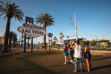 Tourists line up to take photographs at the "Welcome to Fabulous Las Vegas" sign despite the he ...