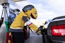 Golden Knights mascot Chance pumps free gas to a customer at Smith’s Marketplace in this Revi ...