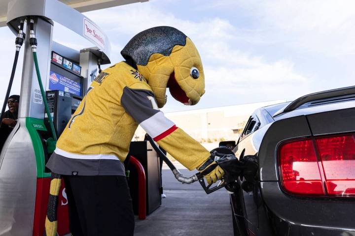 Golden Knights mascot Chance pumps free gas to a customer at Smith’s Marketplace in this Revi ...