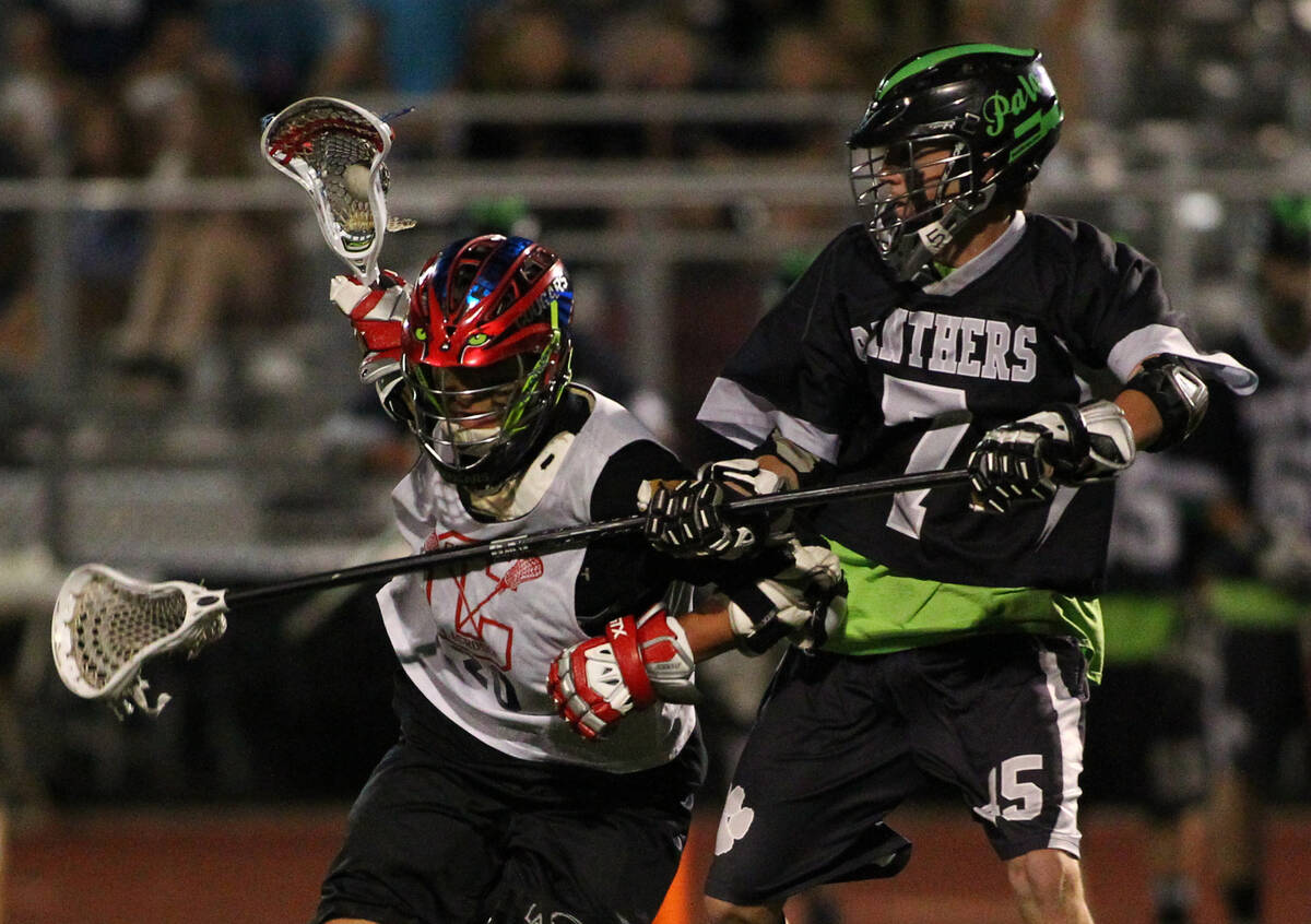 Coronado's Blake Day, left, drives towards the goal as Palo Verde's Cory Christensen body check ...