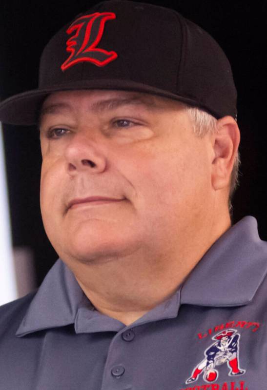 Liberty football head coach Rich Muraco poses for a photo during a preseason meeting and media ...