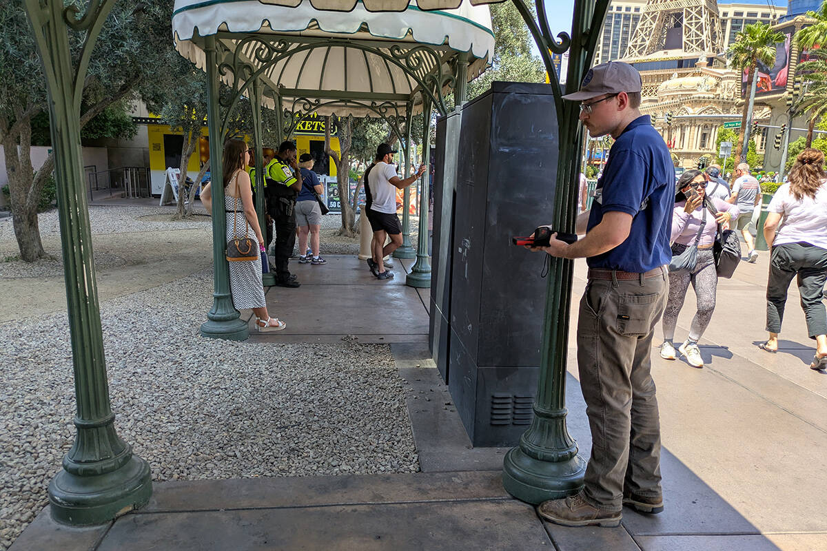 A Nevada OSHA investigator checks a bus stop site on the Las Vegas Strip in an undated photo ob ...