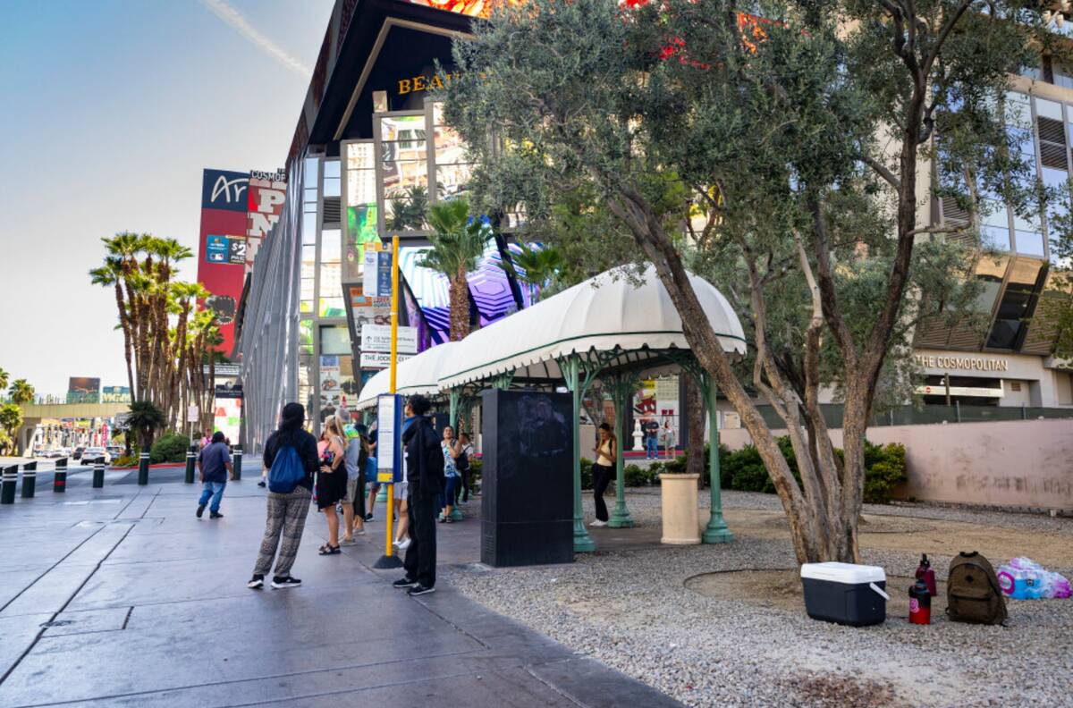 People wait at a Regional Transportation Commission bus stop between the Bellagio and The Cosmo ...
