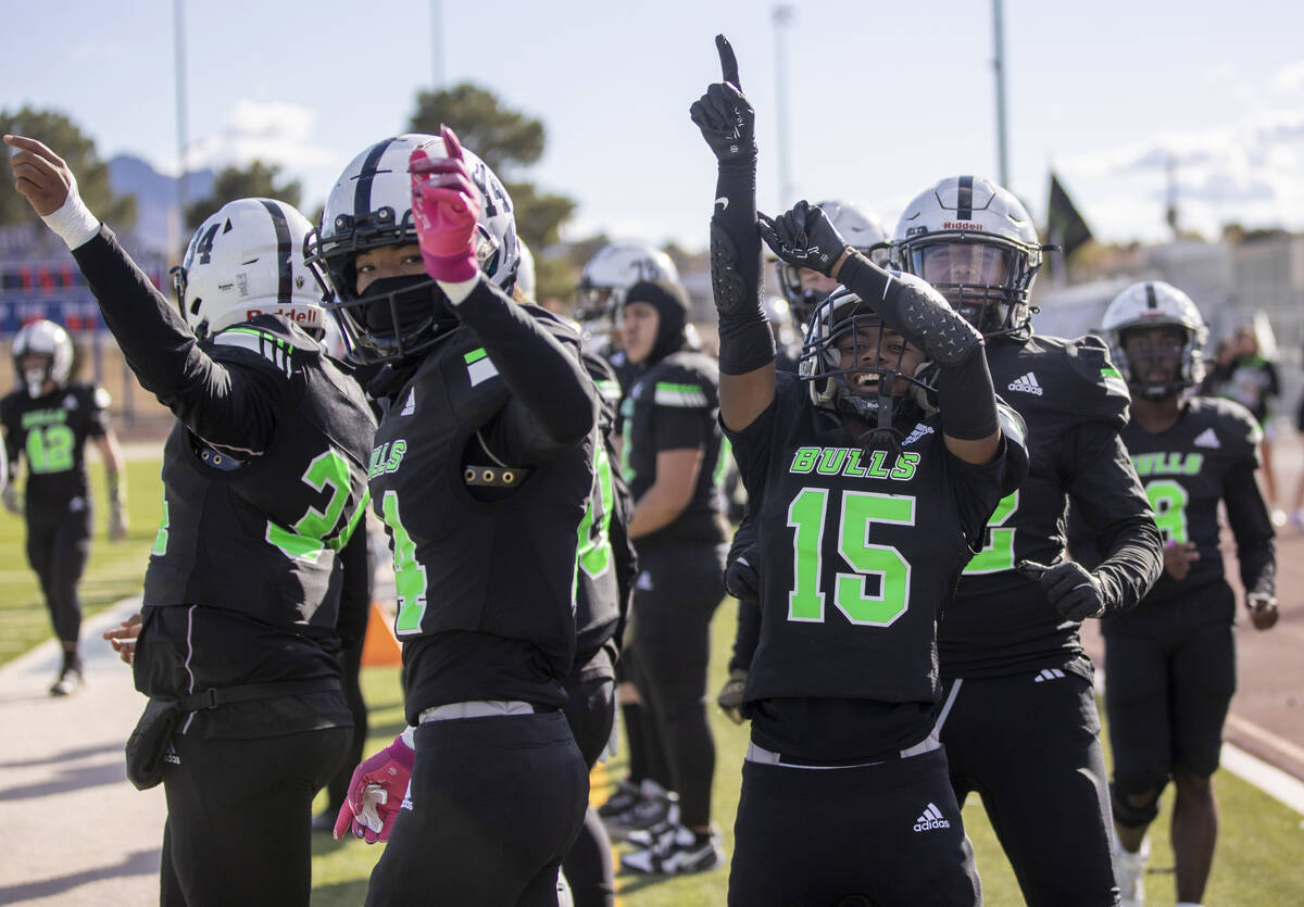 The SLAM! Nevada sideline celebrates after a touchdown is scored during the 3A state semif ...