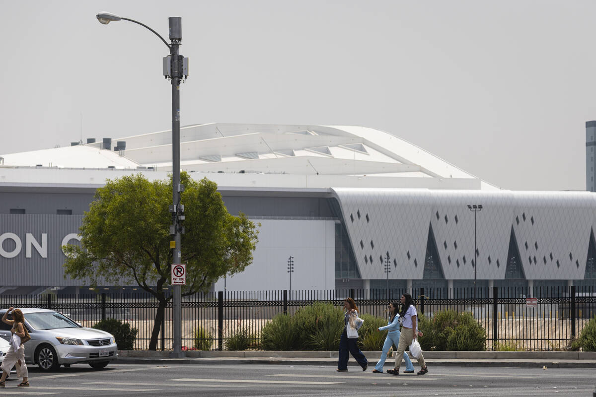 A hazy sky due to smoke from California wildfires is seen as people walk along the Strip near t ...
