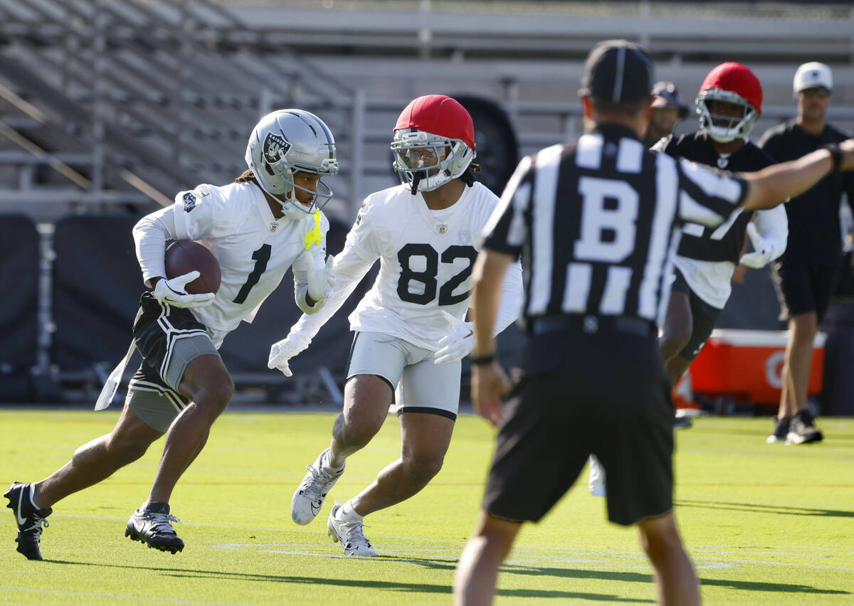 Raiders wide receiver Tre Tucker (1) is chased by wide receiver Kawaan Baker (82) after catchin ...