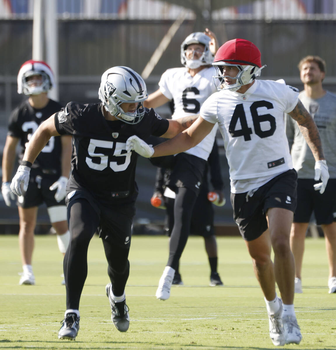 Raiders linebacker Cody Lindenberg (55) and tight end Carter Runyon (46) sprint to recover punt ...