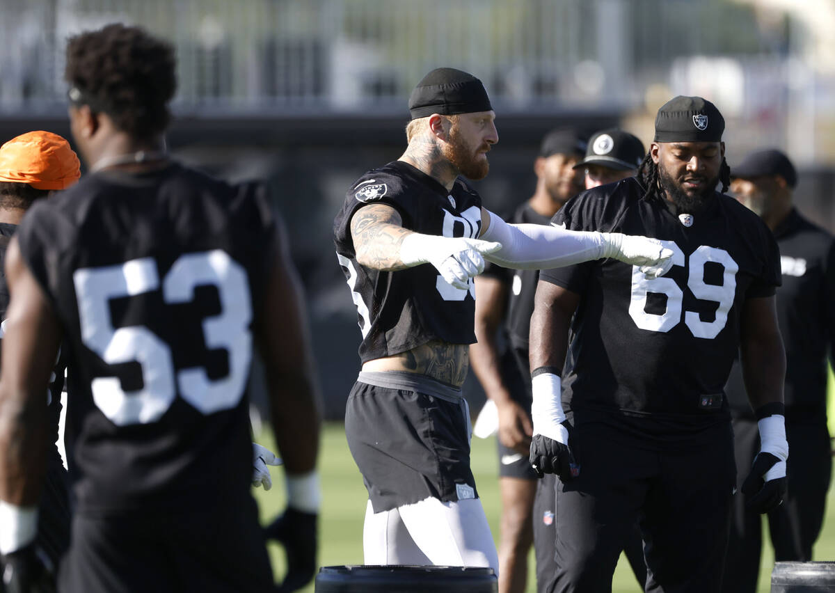 Raiders linebacker Amari Gainer (53) defensive end Maxx Crosby (98) defensive tackle Adam Butle ...