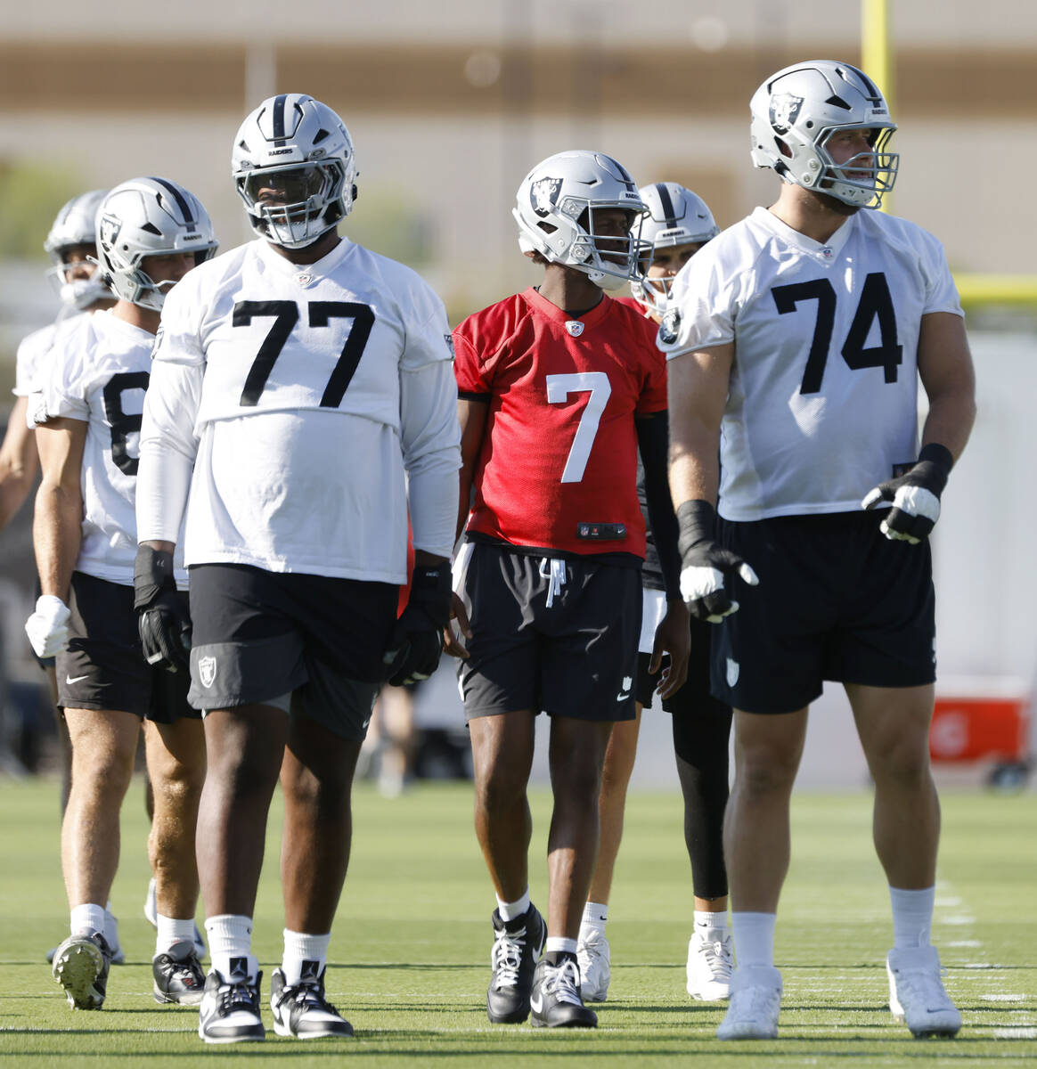 Raiders offensive tackles Thayer Munford Jr. (77) quarterback Geno Smith (7) and Kolton Miller ...