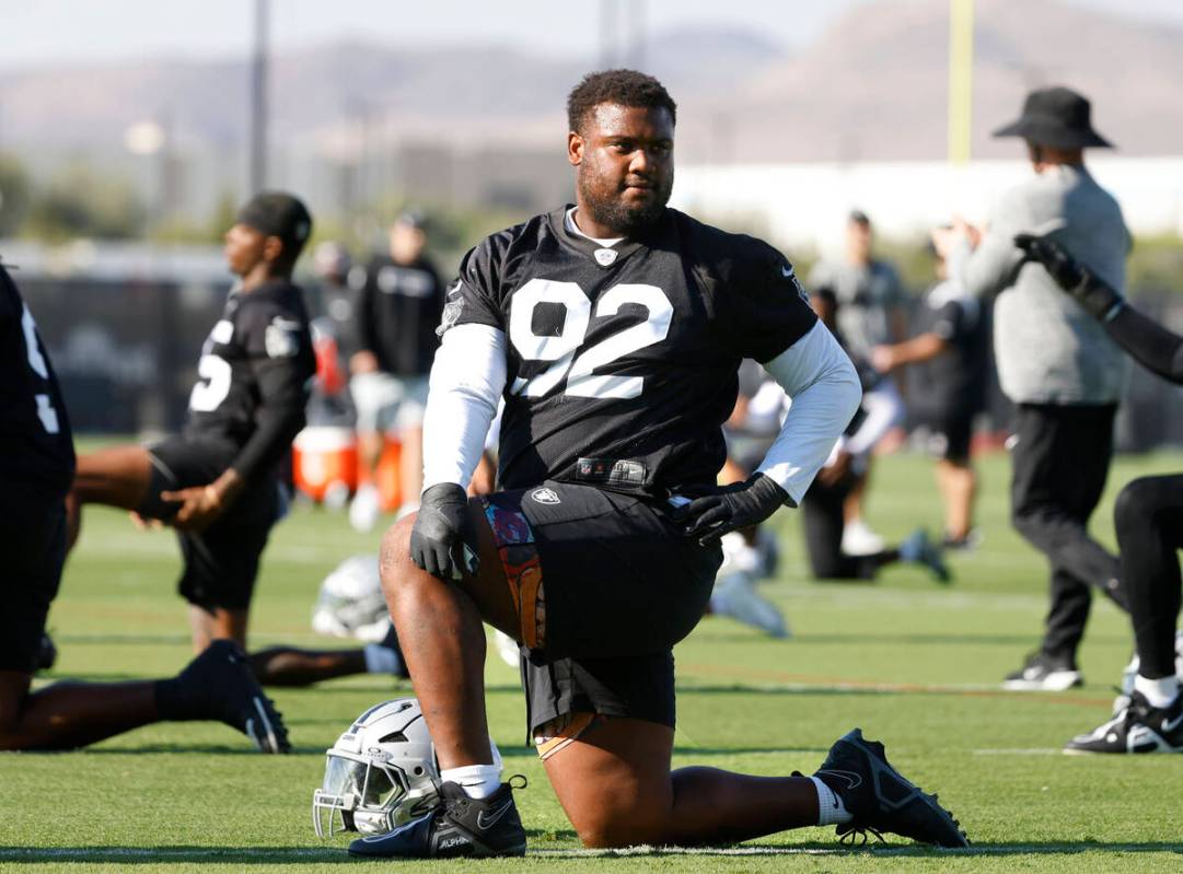 Raiders defensive tackle JJ Pegues (92) stretches during the team’s training camp at the ...