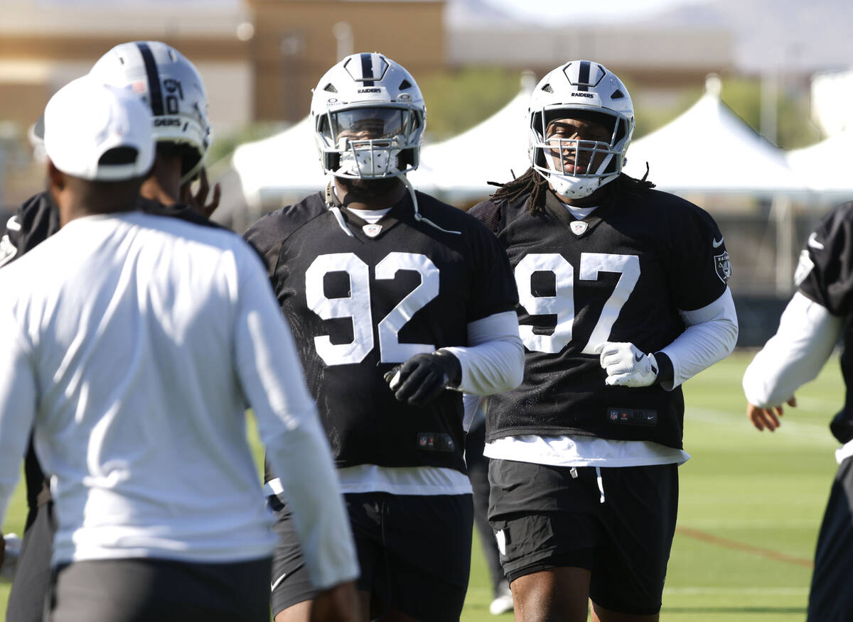 Raiders defensive tackle JJ Pegues (92) defensive tackle Tonka Hemingway (97) warm up during th ...