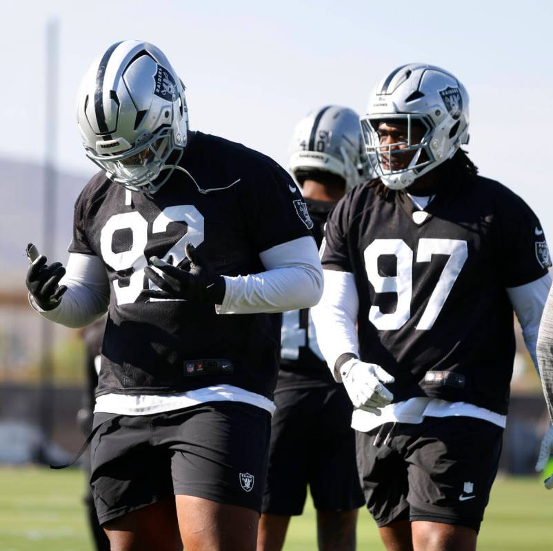 Raiders defensive tackle JJ Pegues (92) defensive tackle Tonka Hemingway (97) prepare to warm u ...