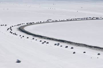 Cars form a line near the race track at the Bonneville Salt Flats near Wendover, Utah, Aug. 13, ...