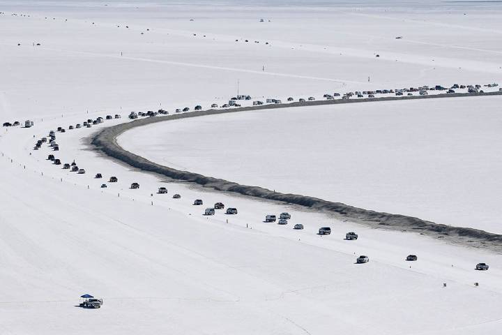 Cars form a line near the race track at the Bonneville Salt Flats near Wendover, Utah, Aug. 13, ...