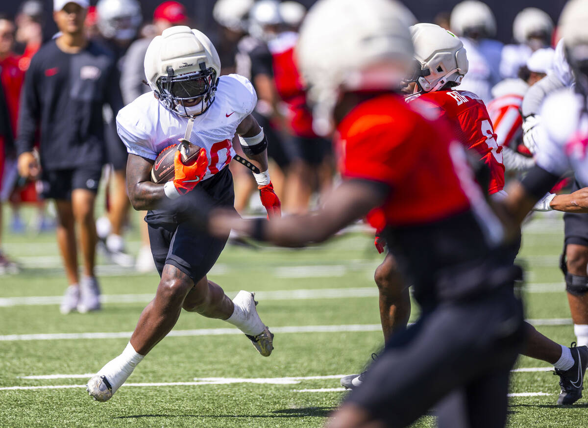 UNLV running back Jaylon Glover (20) turns the corner looking for more yards on a run during fo ...