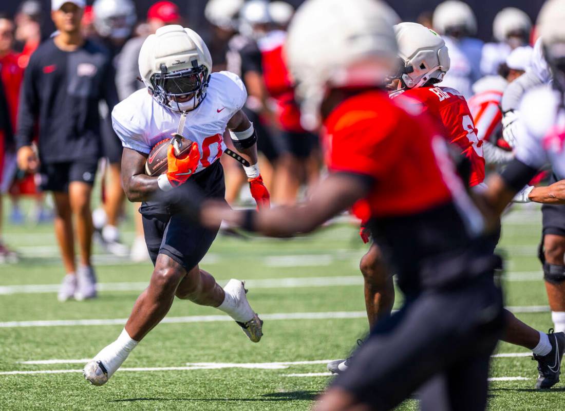 UNLV running back Jaylon Glover (20) turns the corner looking for more yards on a run during fo ...